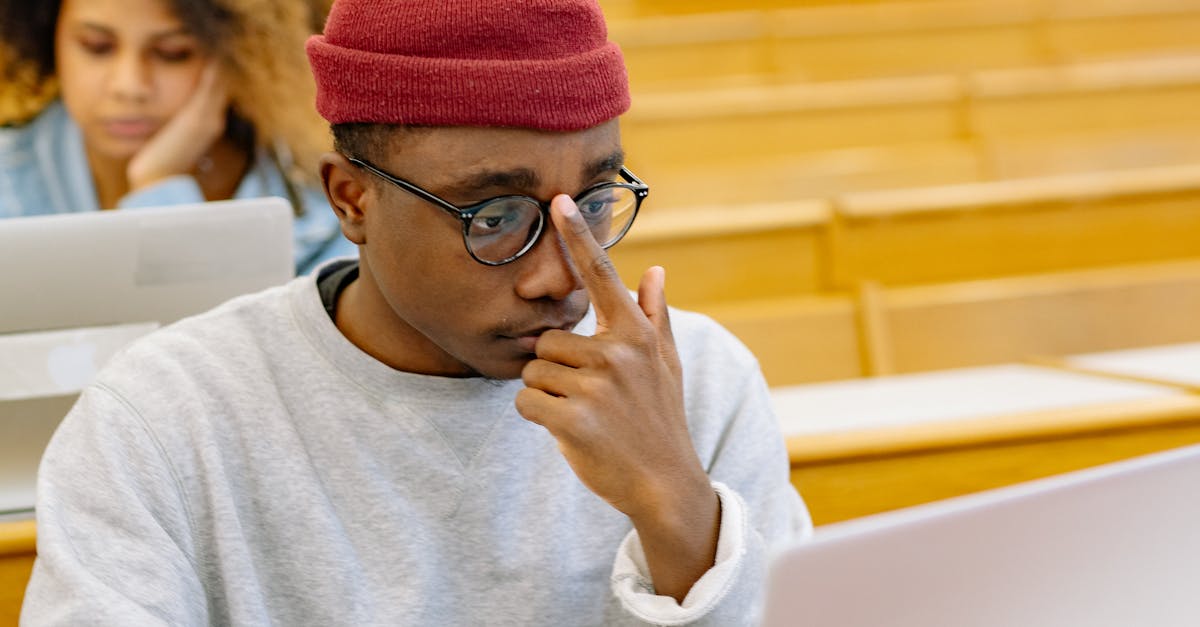 Students taking notes on laptops in a university lecture hall