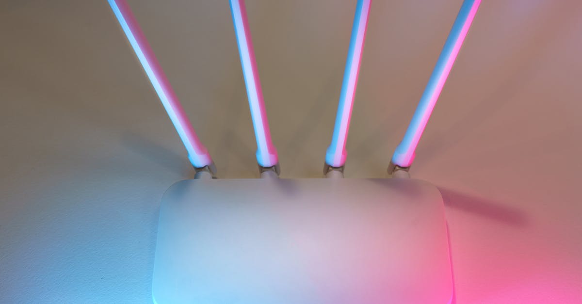 White wireless home internet router with four antennas on a desk