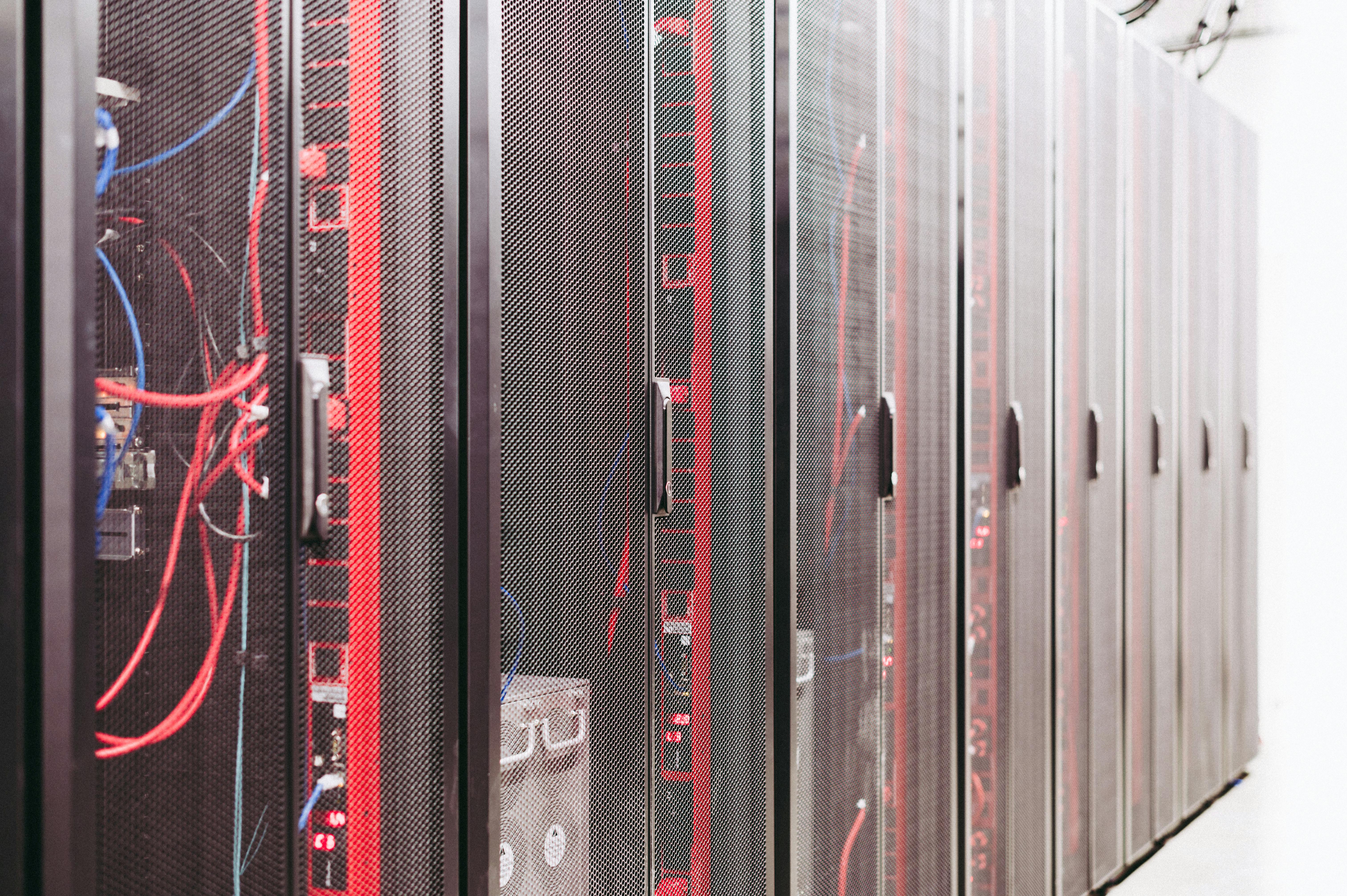 Server racks in a data centre with network cables, depicting cloud storage infrastructure