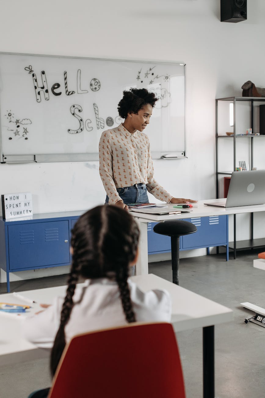 Primary-school teacher reviewing lesson materials at a classroom desk
