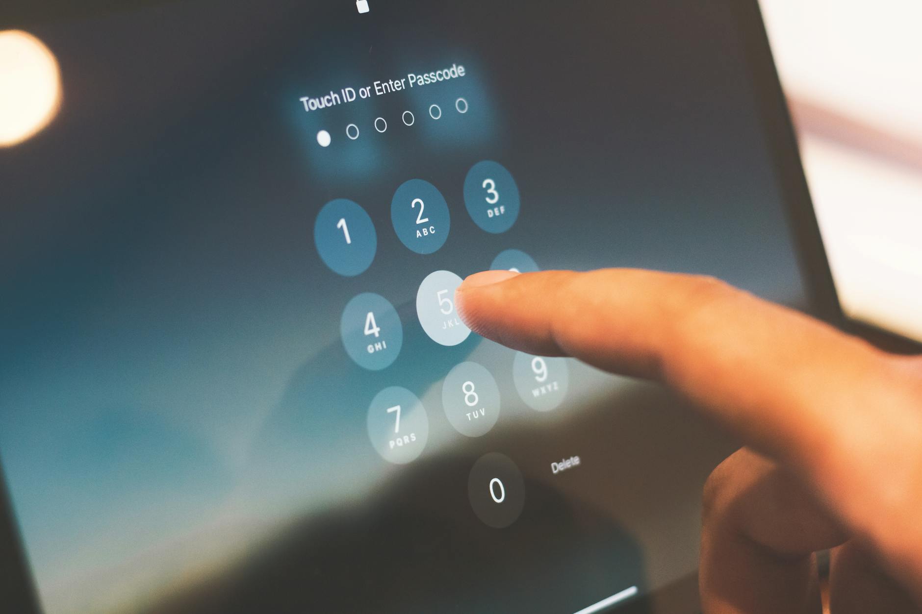 Person entering passcode on a smartphone.