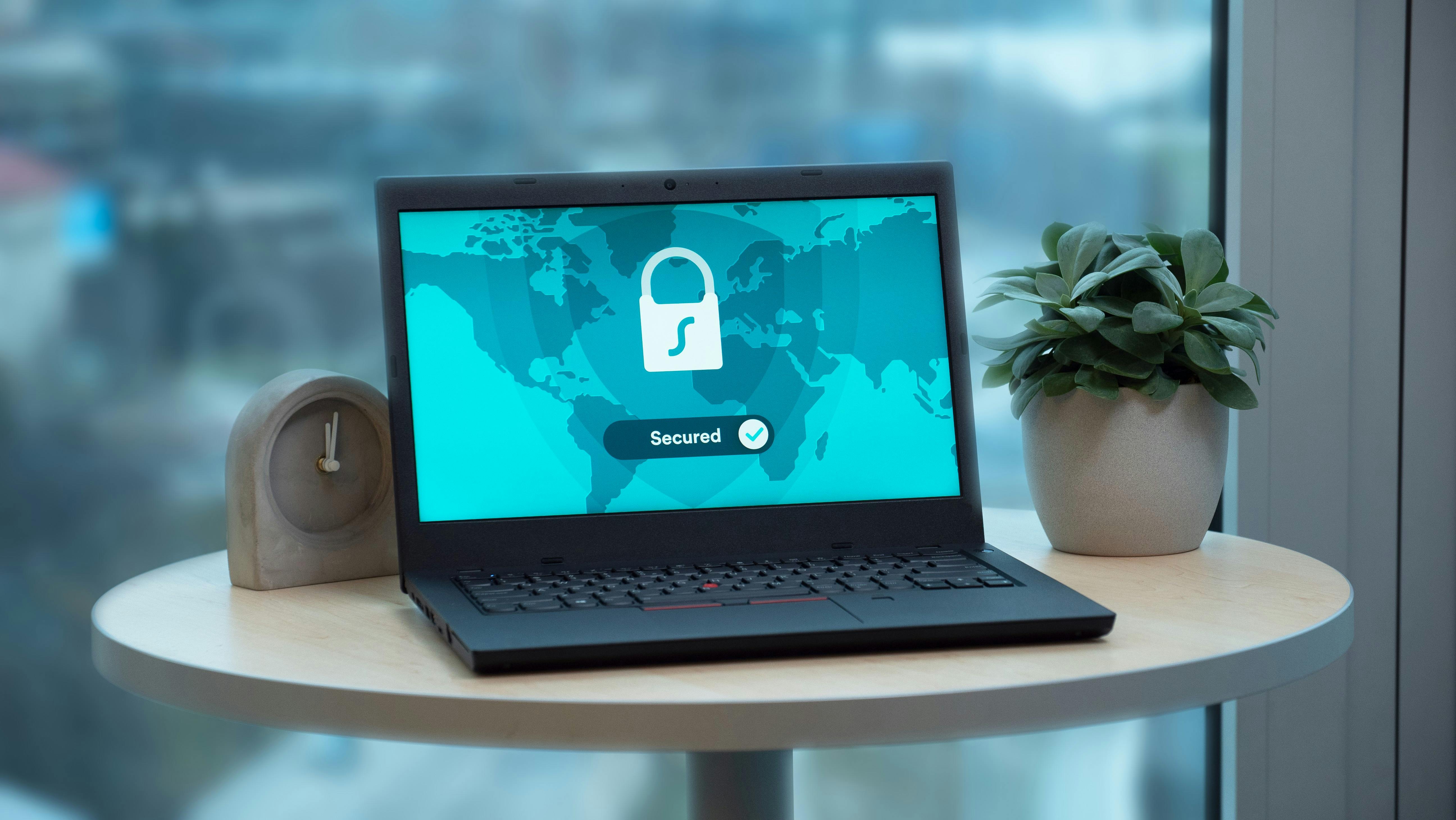 Laptop displaying a security lock icon on a table