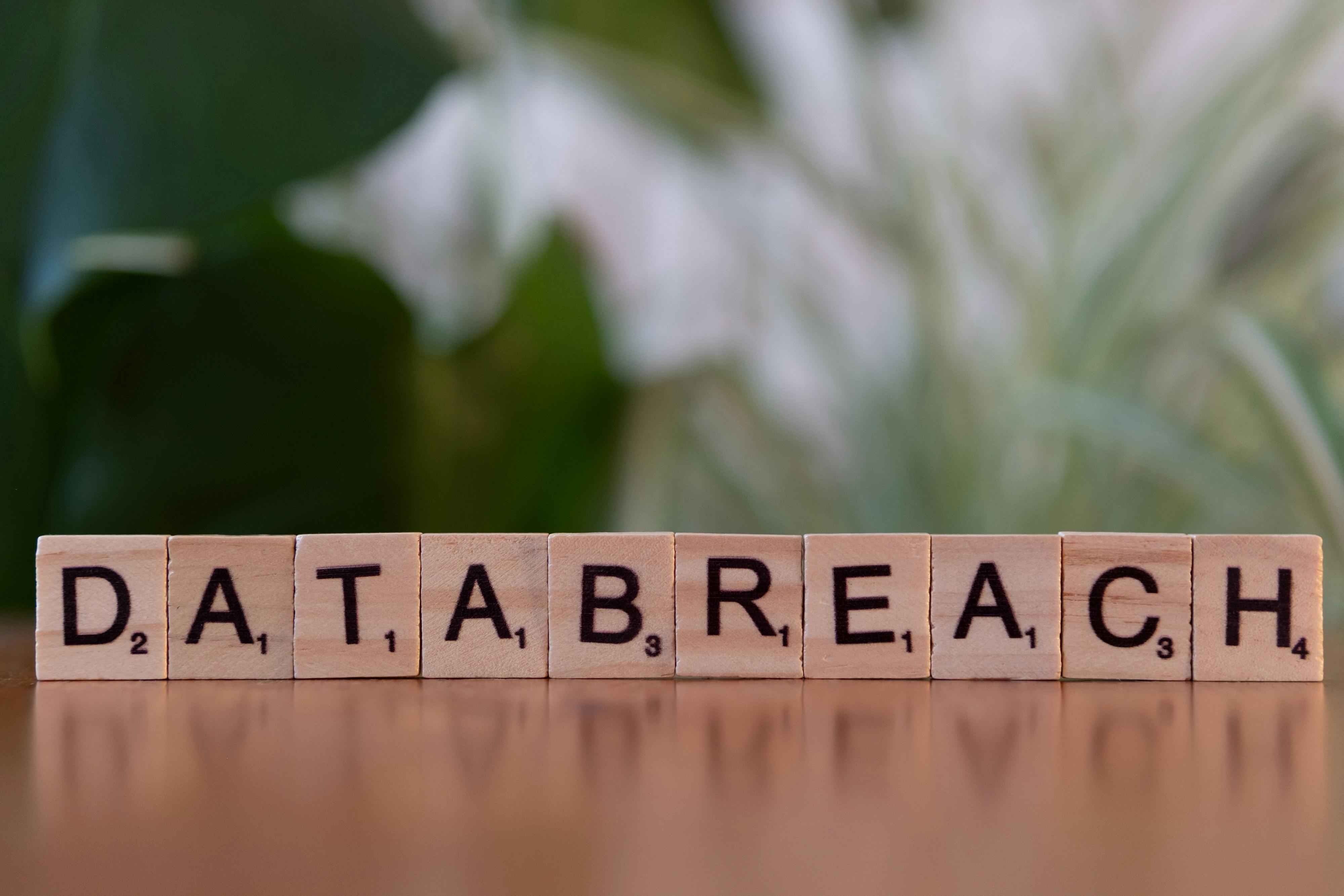 Scrabble tiles spelling 'data breach' on a table, illustrating personal data exposure risks