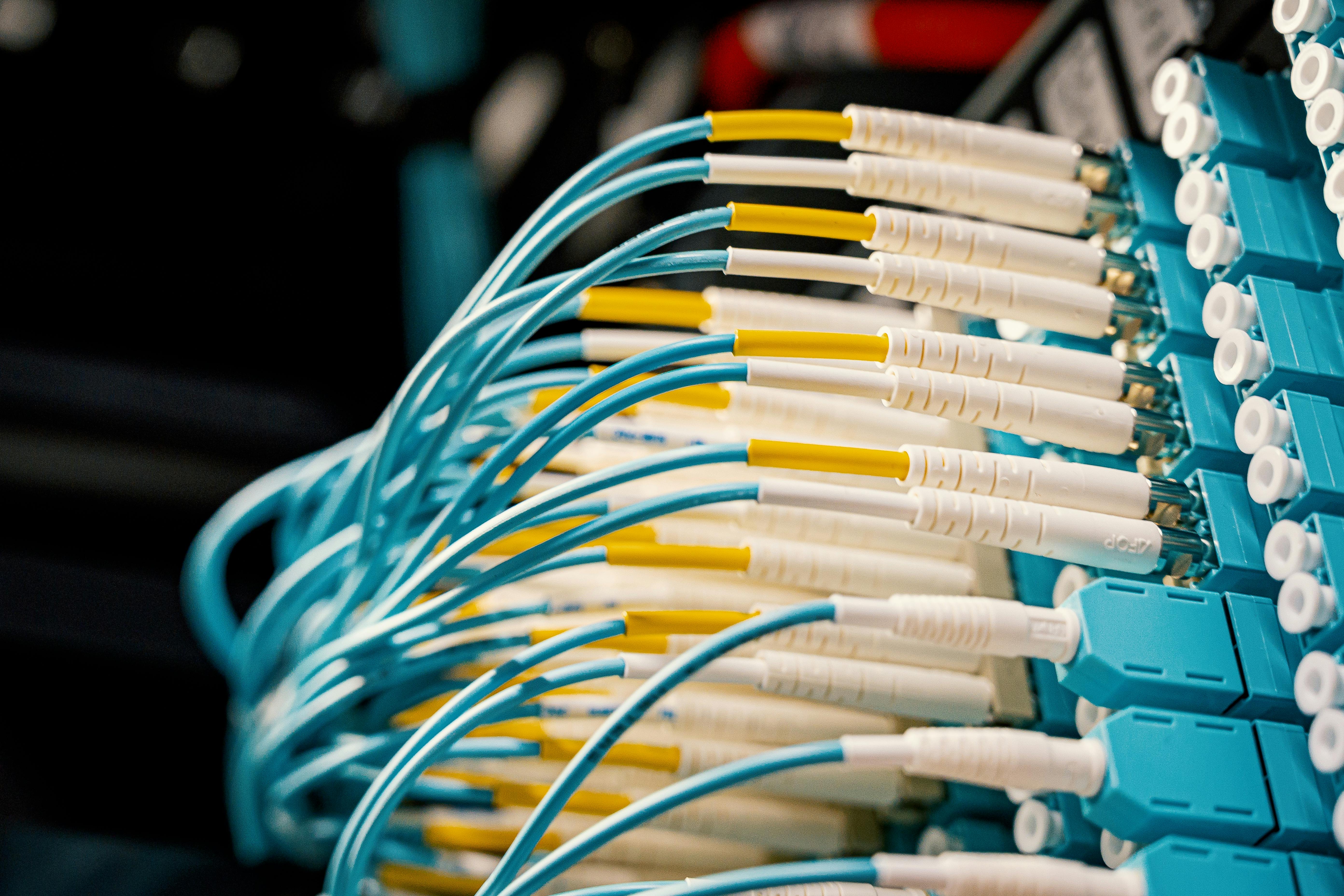 Overhead view of fiber optic switch with connected blue patch cables in a server room