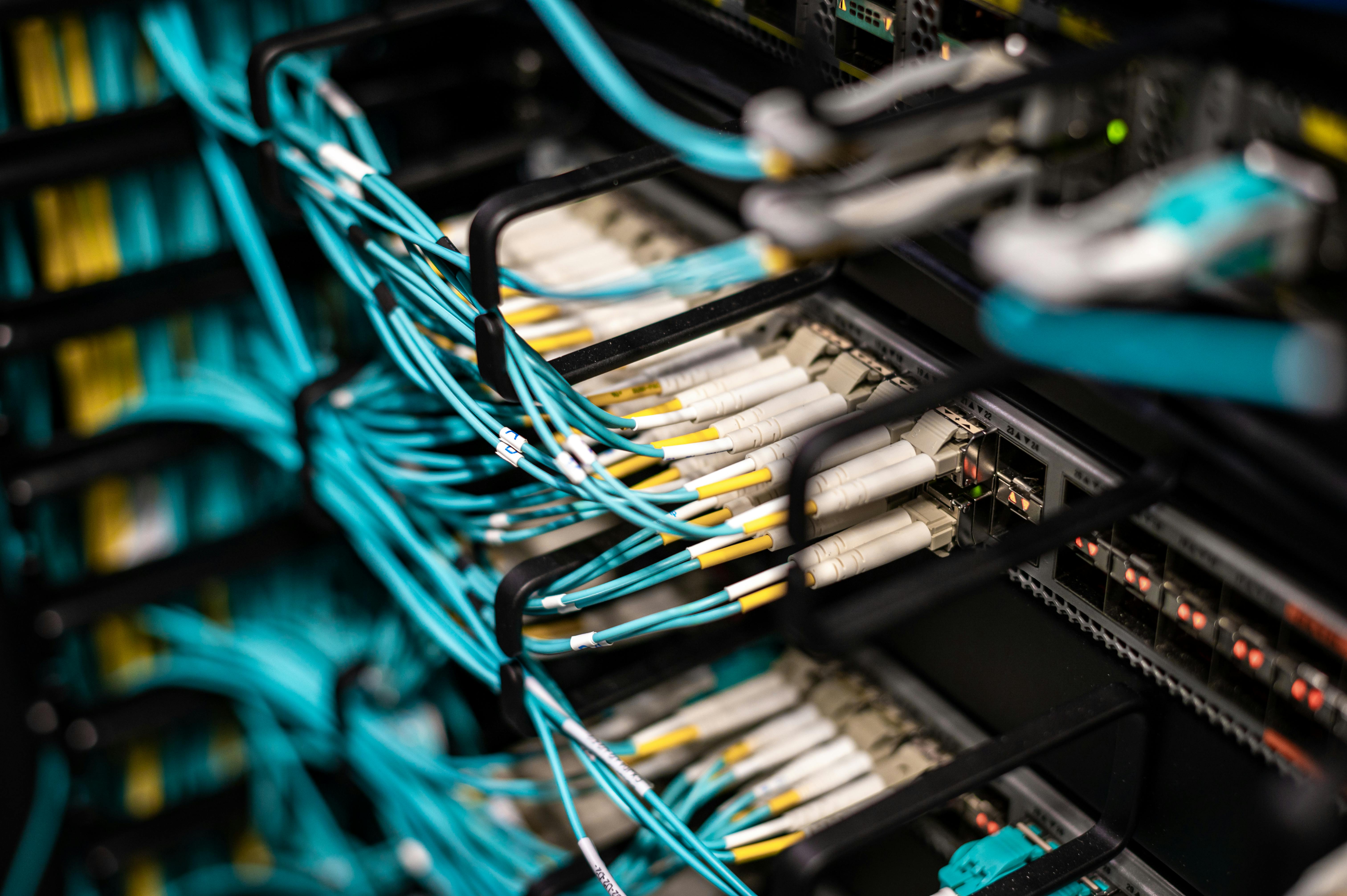 Server racks with patch cables in a modern data centre, representing enterprise data infrastructure and integration