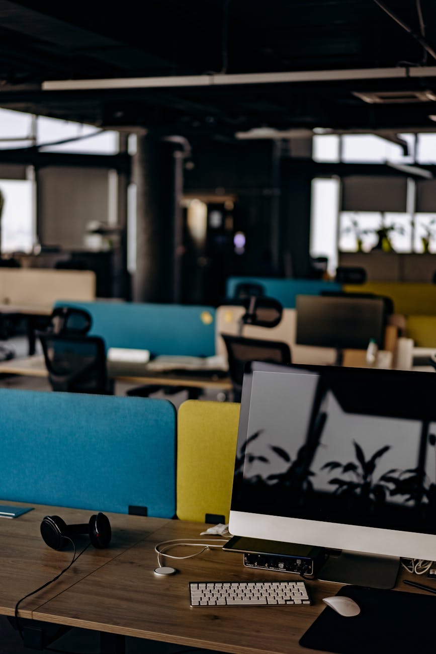 Open office space with computers and colorful partitions at a modern tech workplace