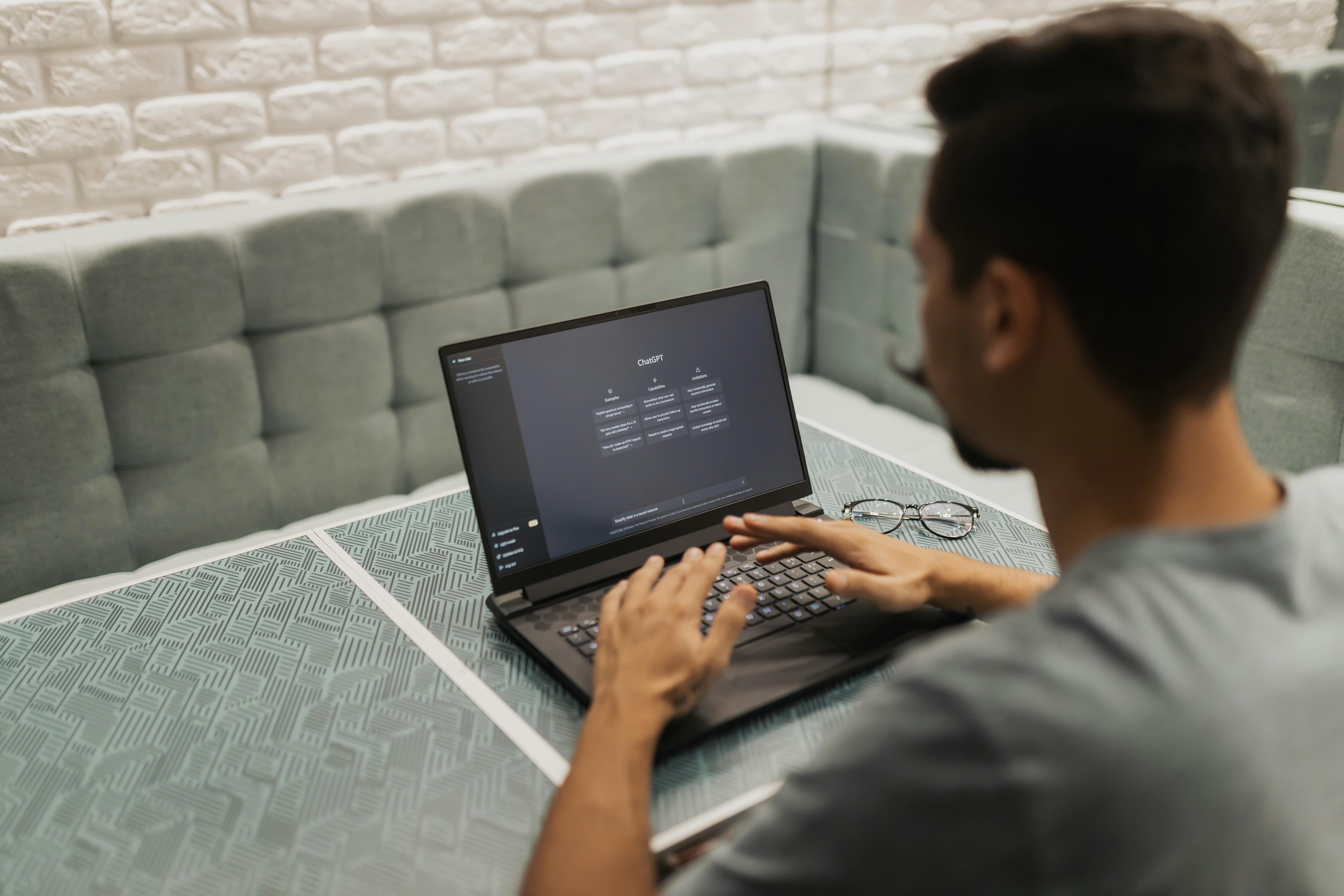 Man working on laptop in modern office with technology focus
