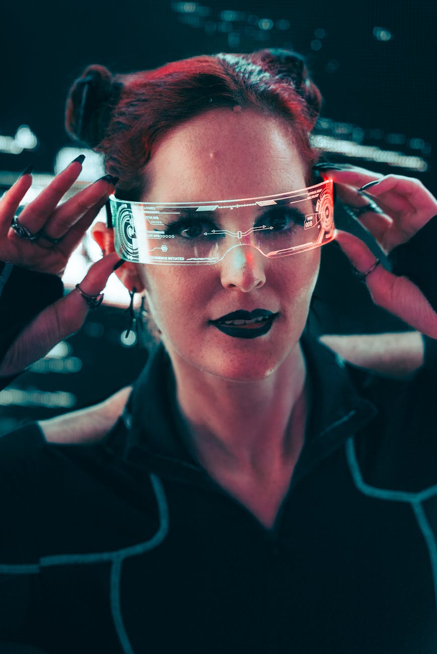 Portrait of a woman in cyber attire wearing futuristic smart glasses against a dark tech backdrop.