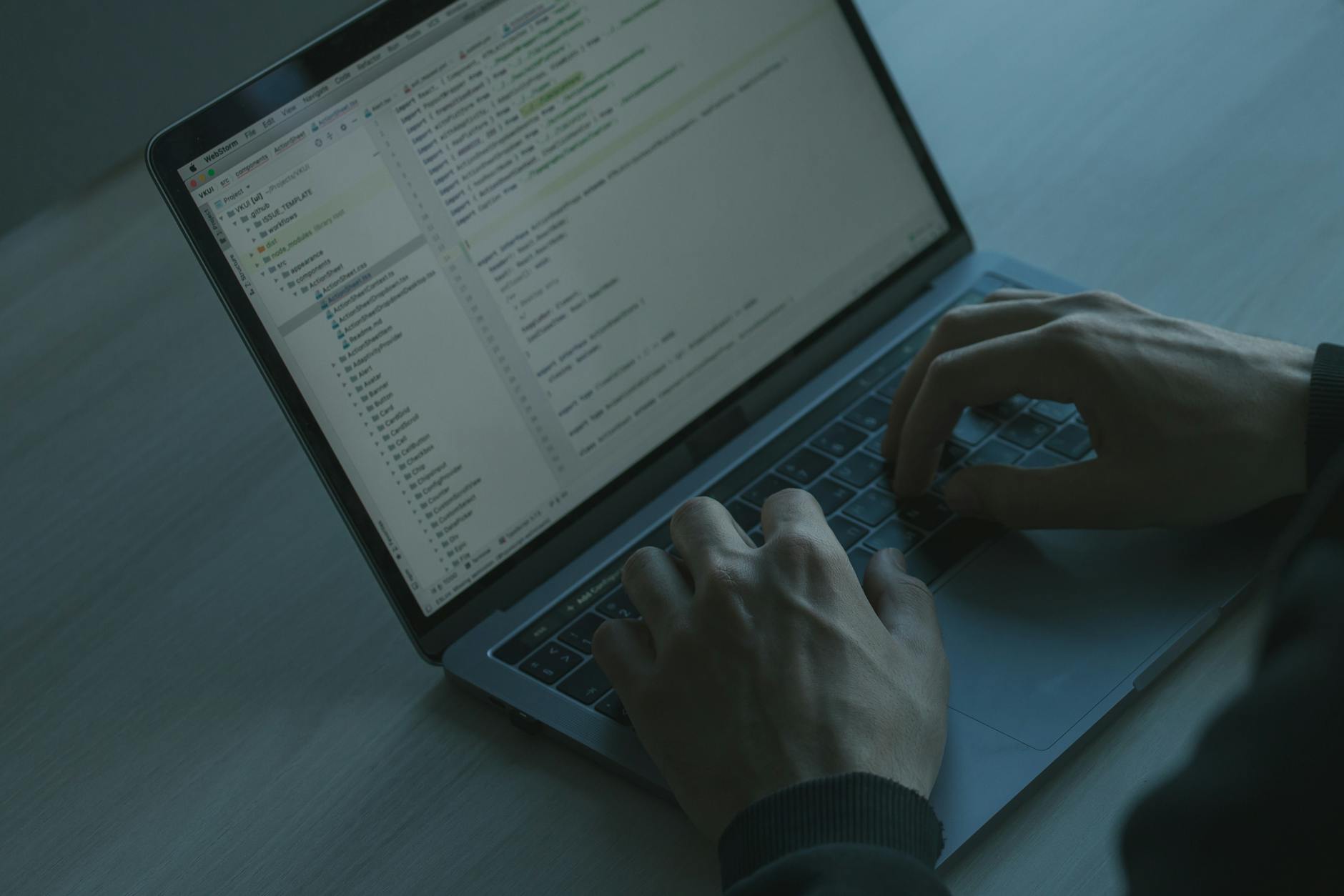Hands typing code on a laptop, illustrating developer workstation security