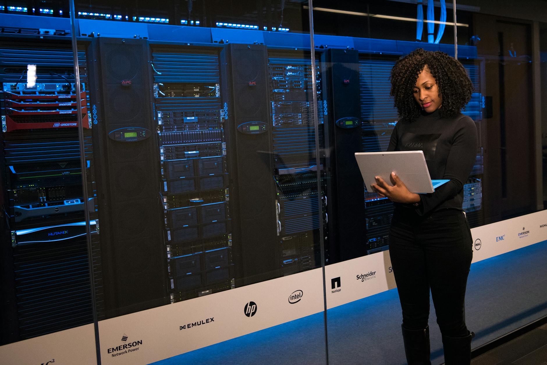 Security staff monitoring servers and network systems in a data centre, illustrating why large enterprises want earlier visibility into frontier AI tools.
