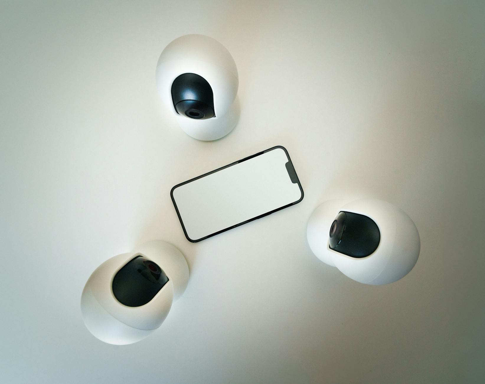 A smartphone displayed alongside monitoring devices, reflecting the surveillance tools at the centre of coercive-control debates.