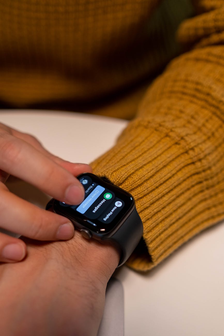 A close-up of a smartwatch screen being tapped, matching the on-watch erase steps used when the iPhone is unavailable.