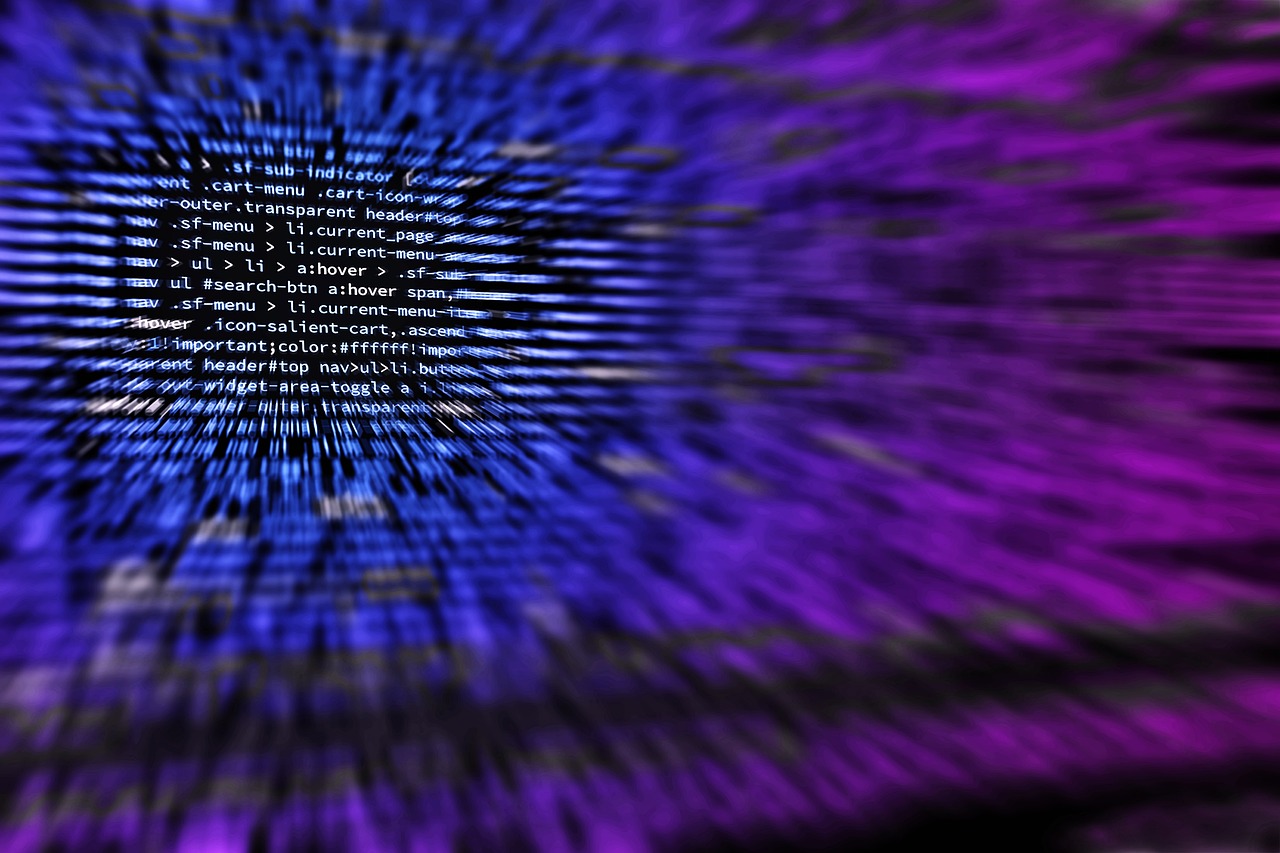 Code on monitors representing AI-assisted cyber operations
