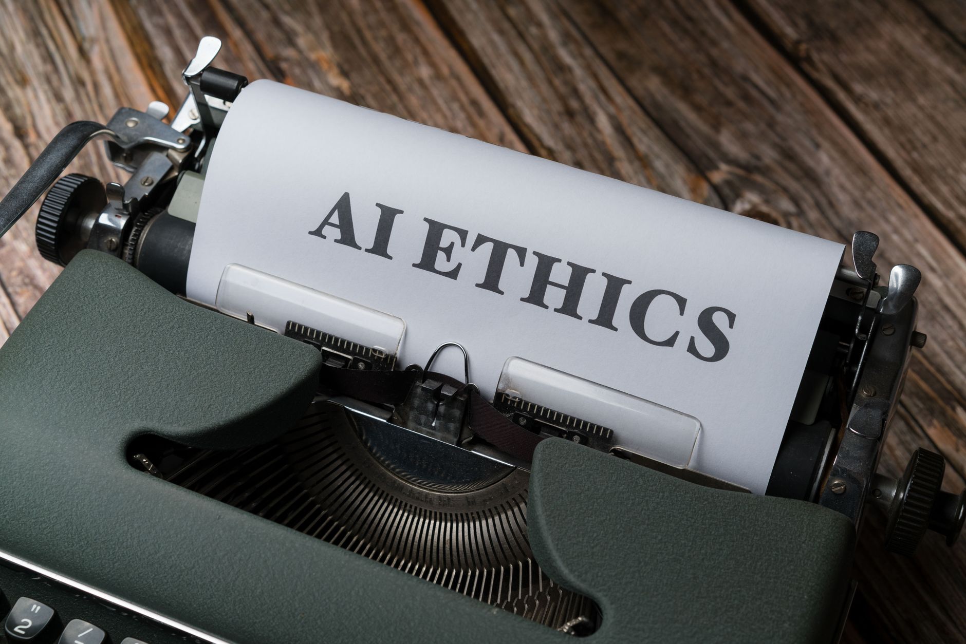 Typewriter page reading AI Ethics, illustrating policy scrutiny of artificial intelligence models