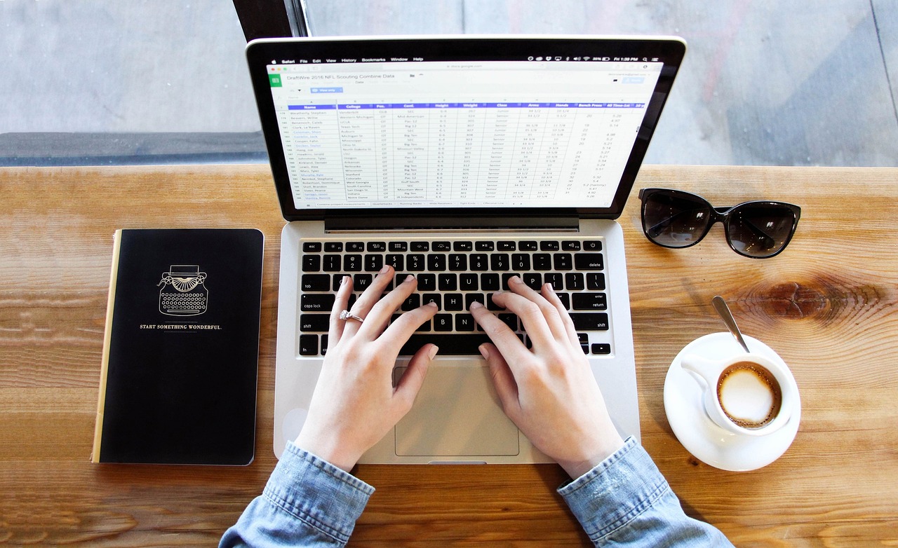 Mac laptop used for spreadsheet work on a desk