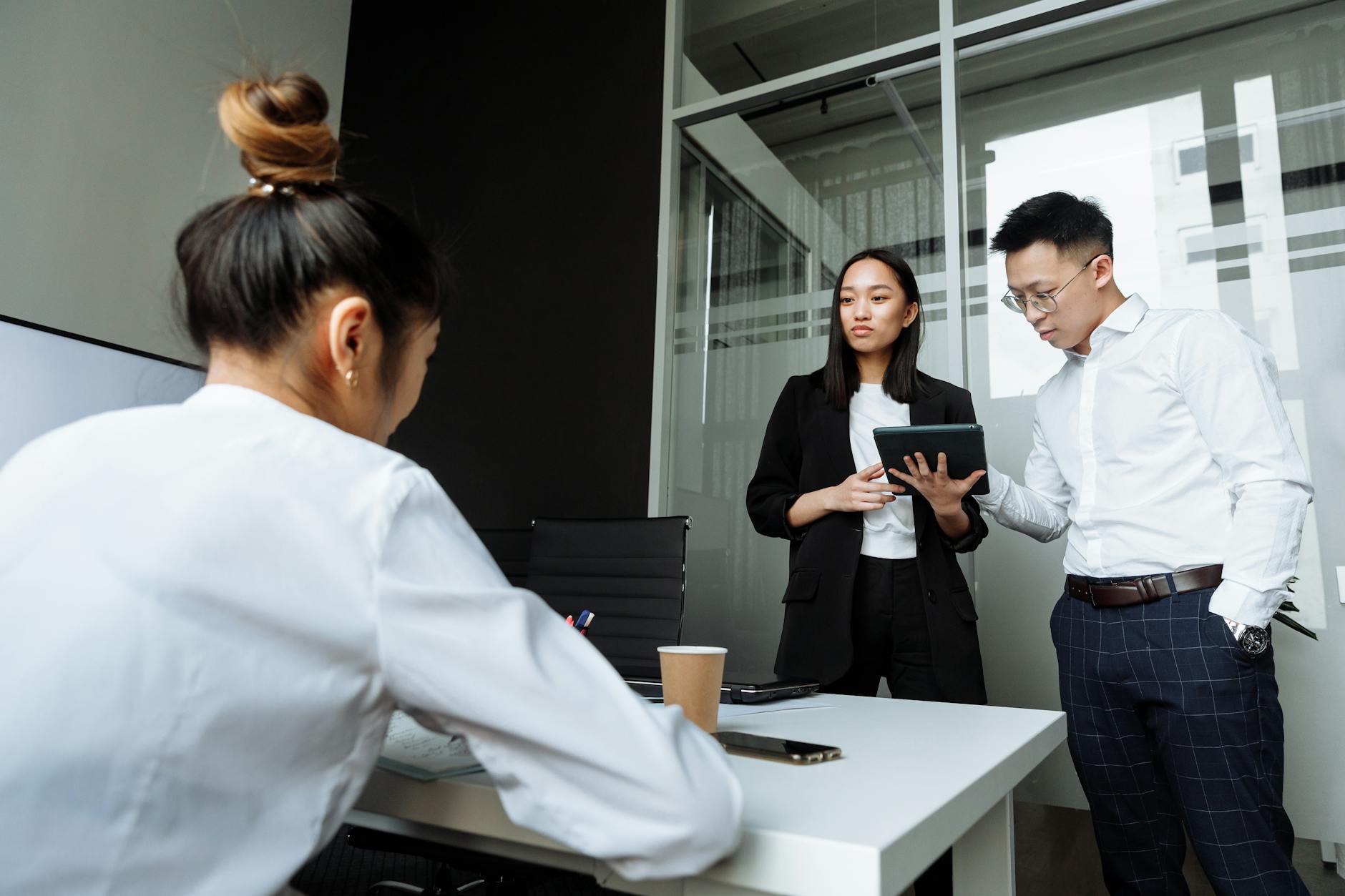 Professional analysing data on a tablet in a modern office environment