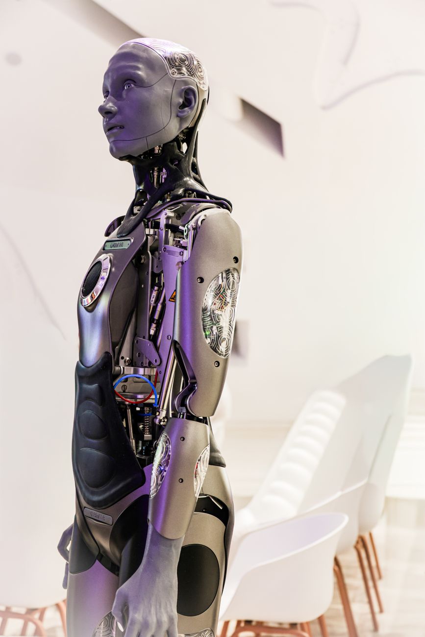 A humanoid robot standing beside NVIDIA branding at a technology conference, symbolising the shift from AI software to physical robotics