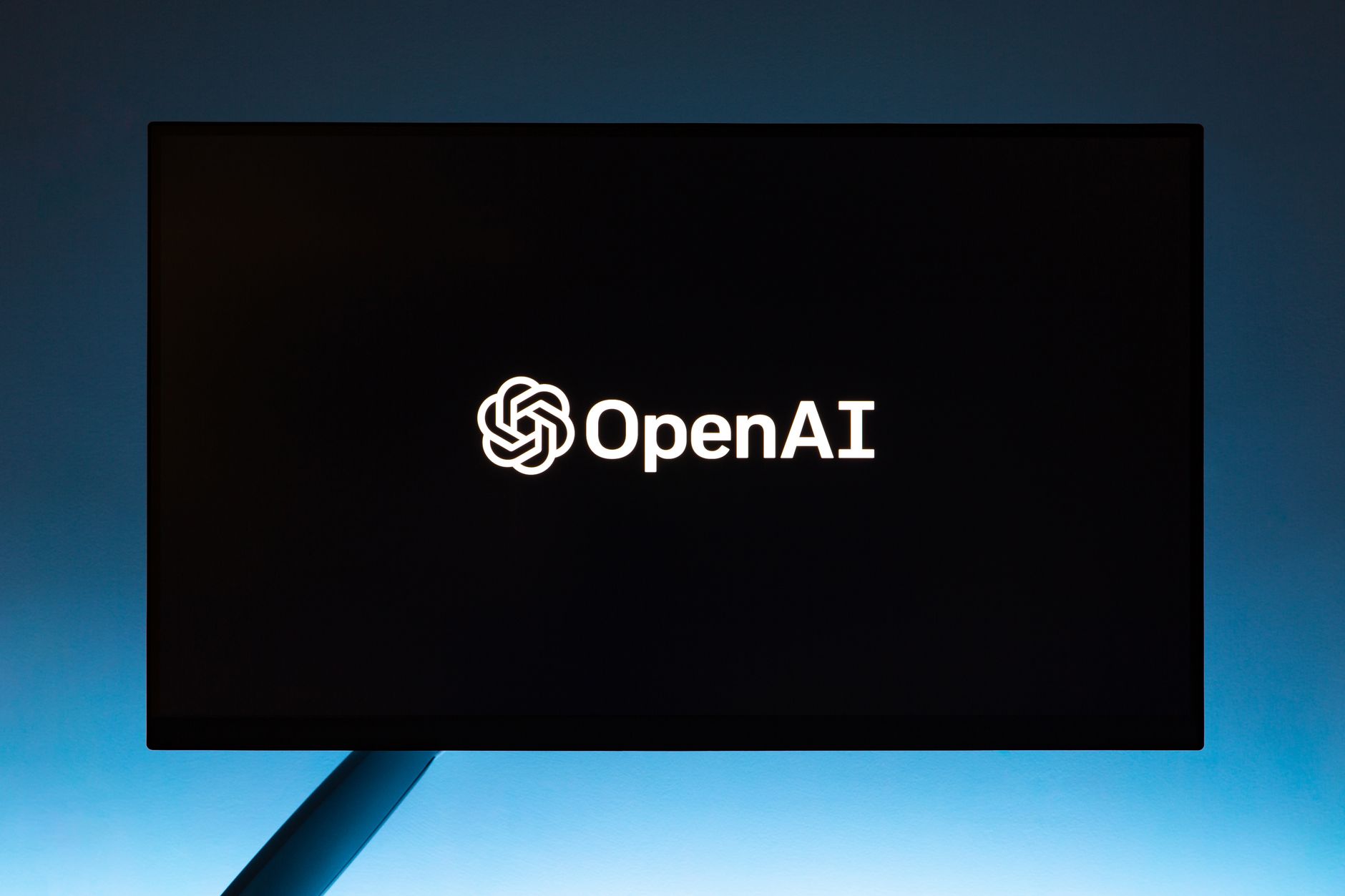 OpenAI logo on a screen against a blue background