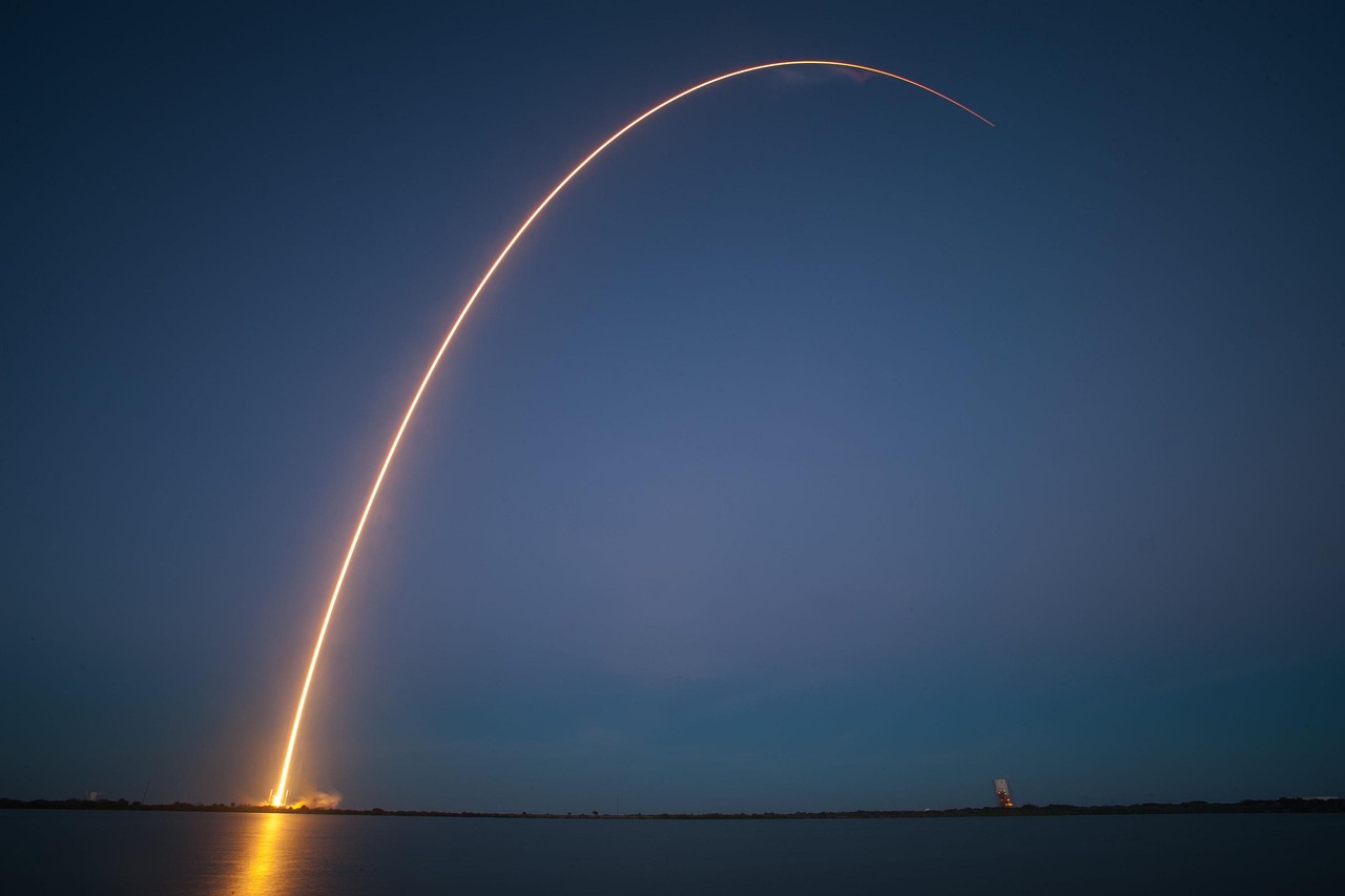 SpaceX rocket lifting off at night as investors weighed the company's public-market debut