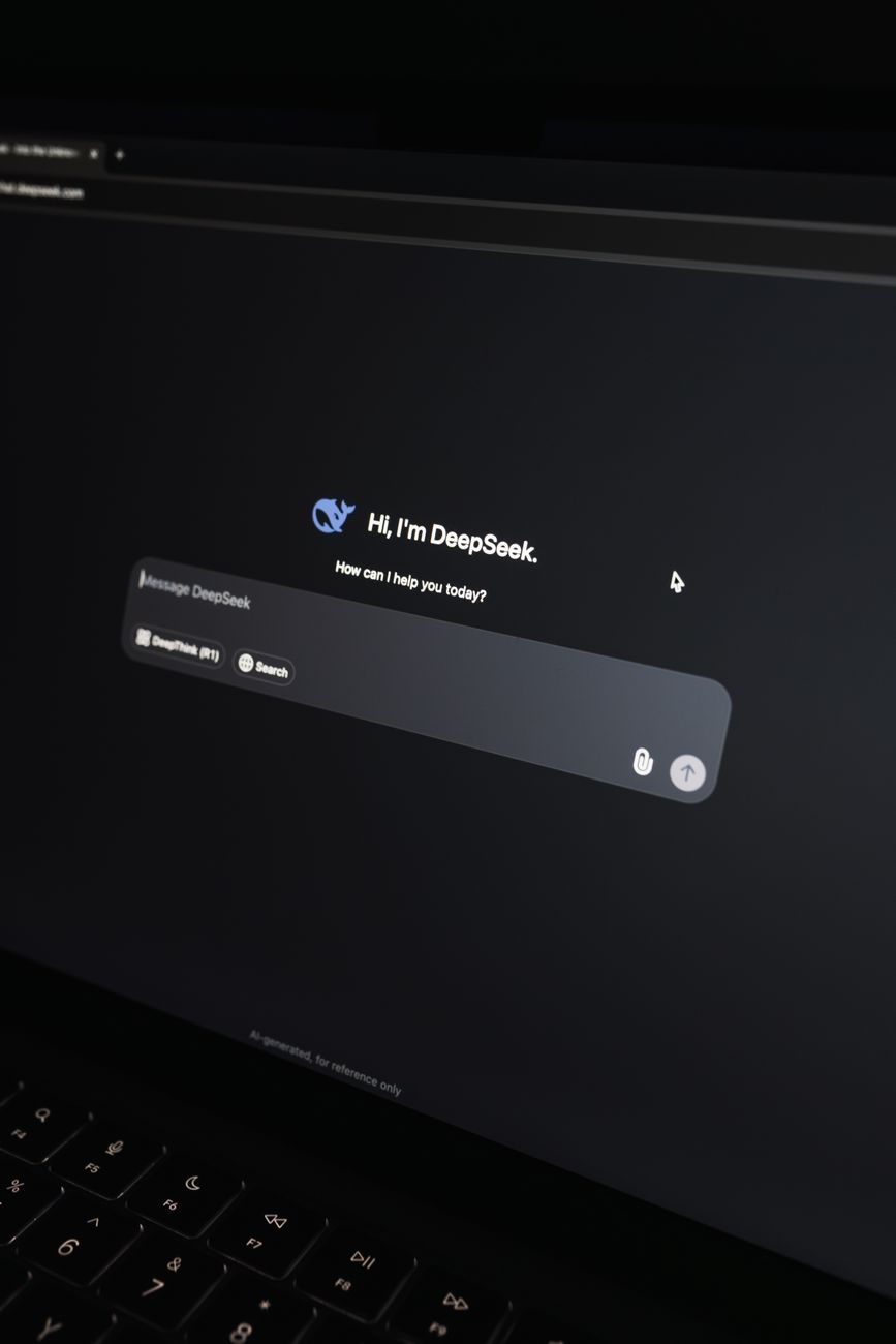 AI chat interface displayed on a laptop screen in a dark office setting.