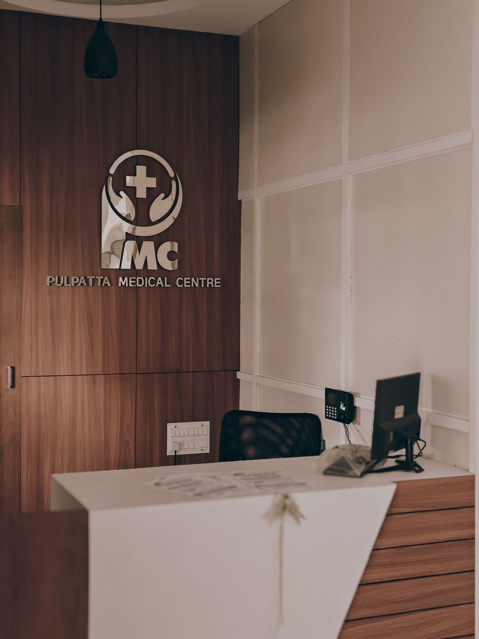 Modern medical clinic reception area with wood-panel accents and waiting seating