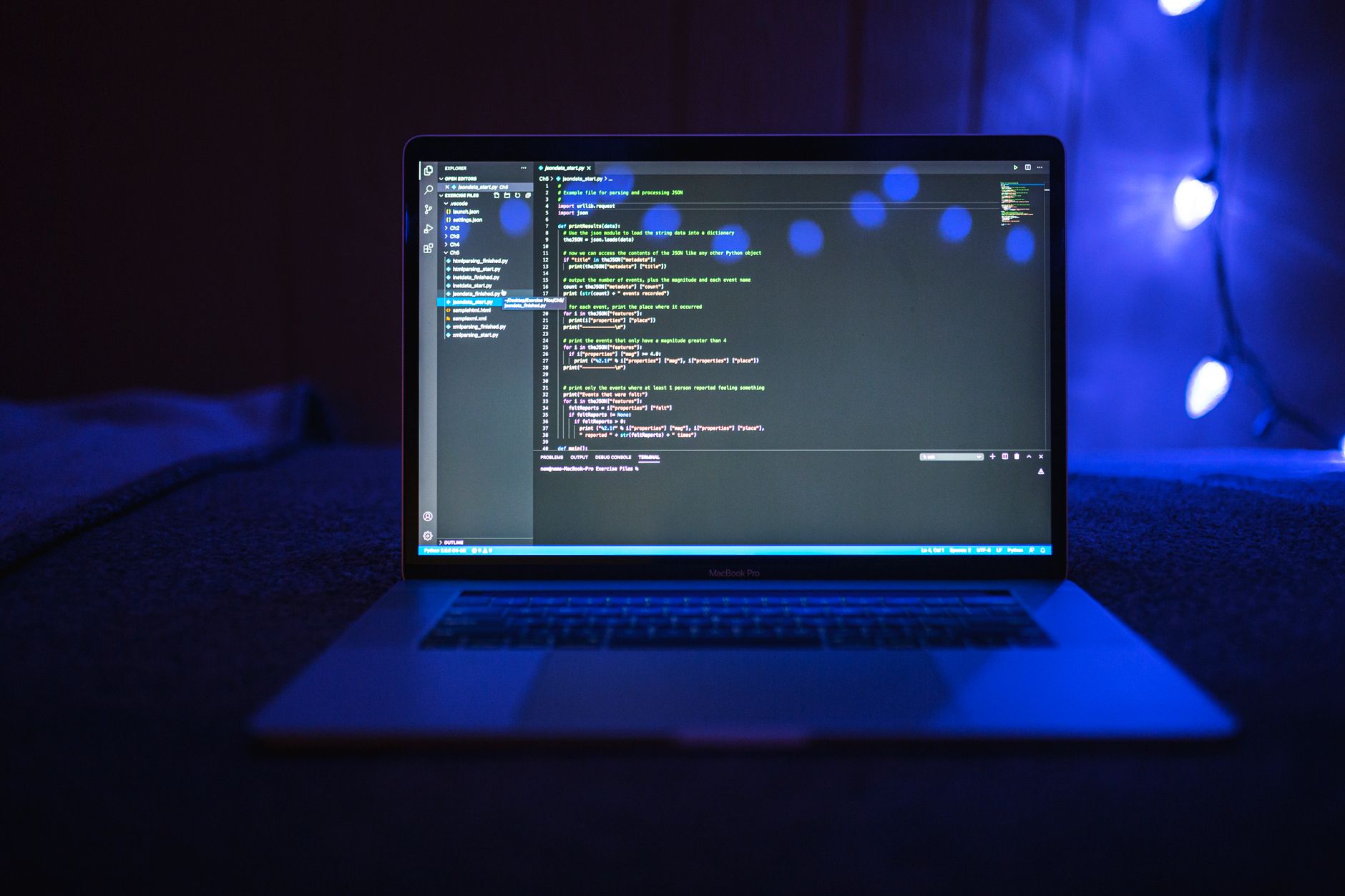 Close-up of a laptop screen displaying code against a dark blue backdrop, illustrating developer-focused AI work.