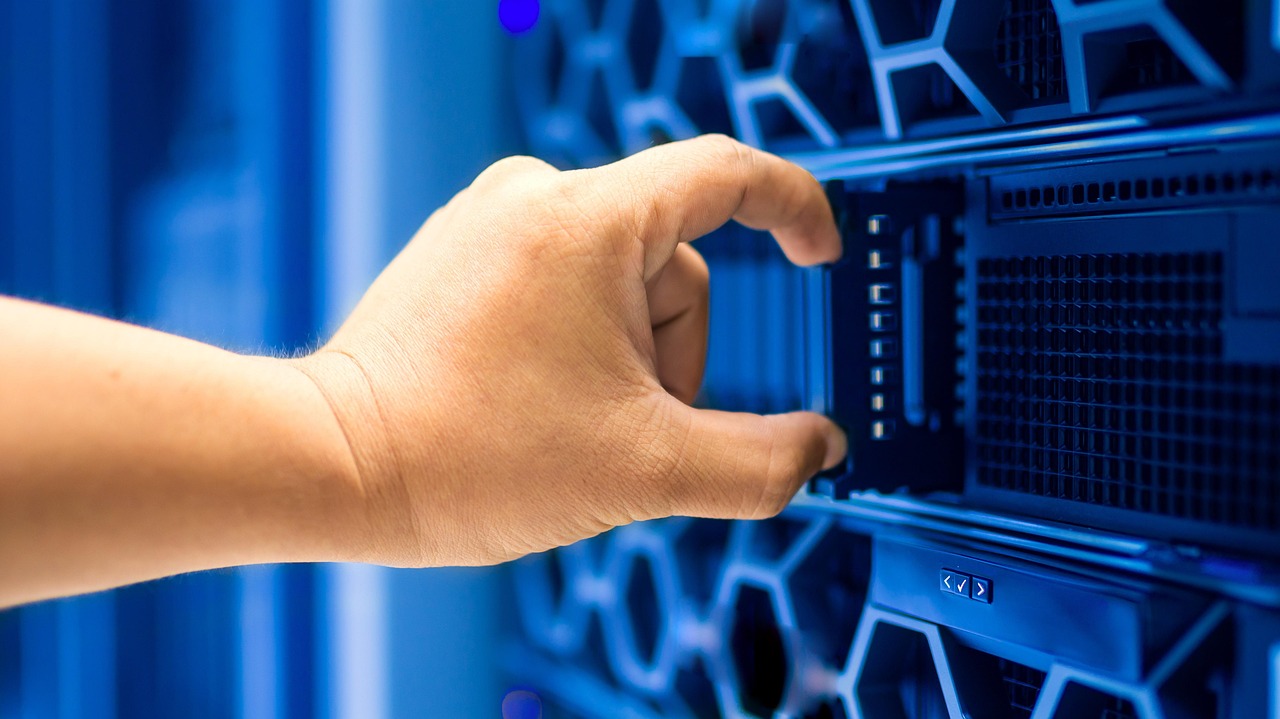Engineer working among server racks in a modern data centre